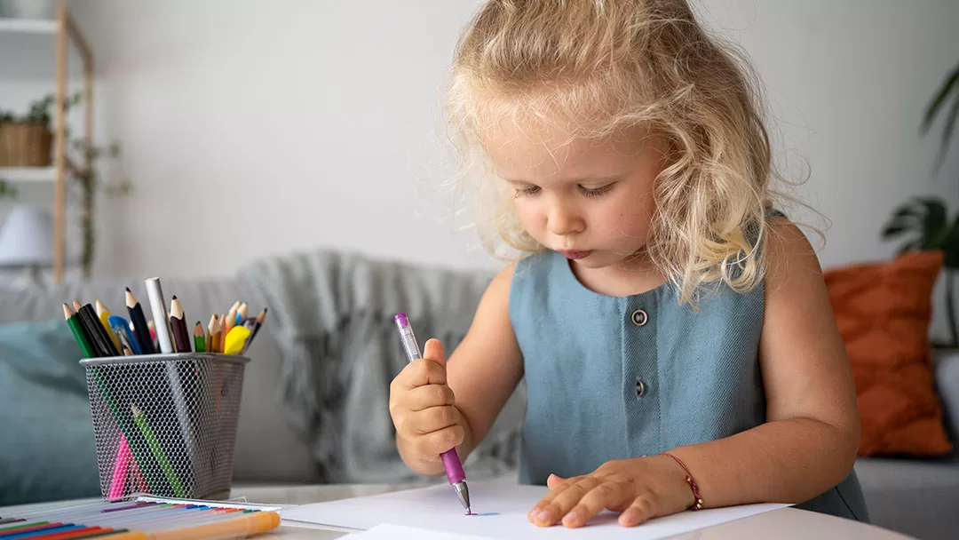 little girl drawing on paper to submit a guest post on Kids on the Coast website